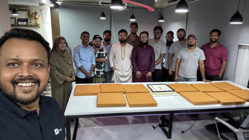 WPManageNinja team celebrating FluentCart’s first birthday with cake